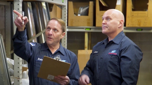 Two employees talking in a wearhouse.