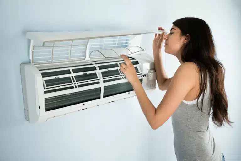 Woman Checking Hot Air Conditioner Denver