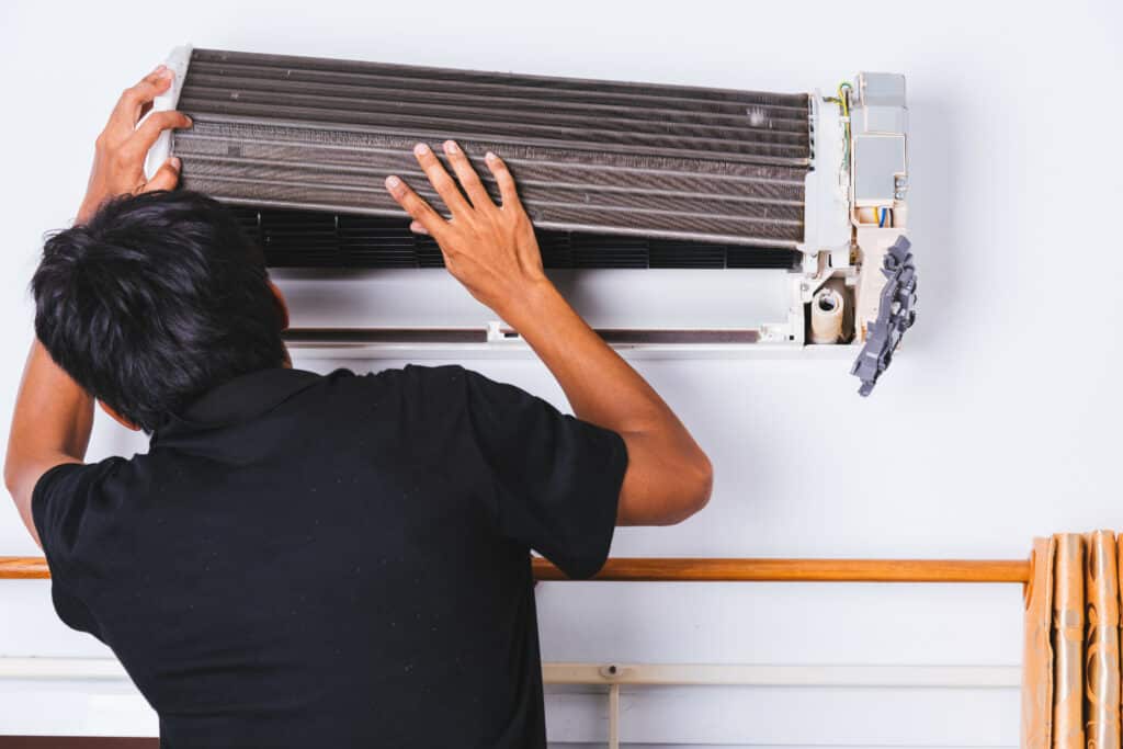 repairman fixing AC